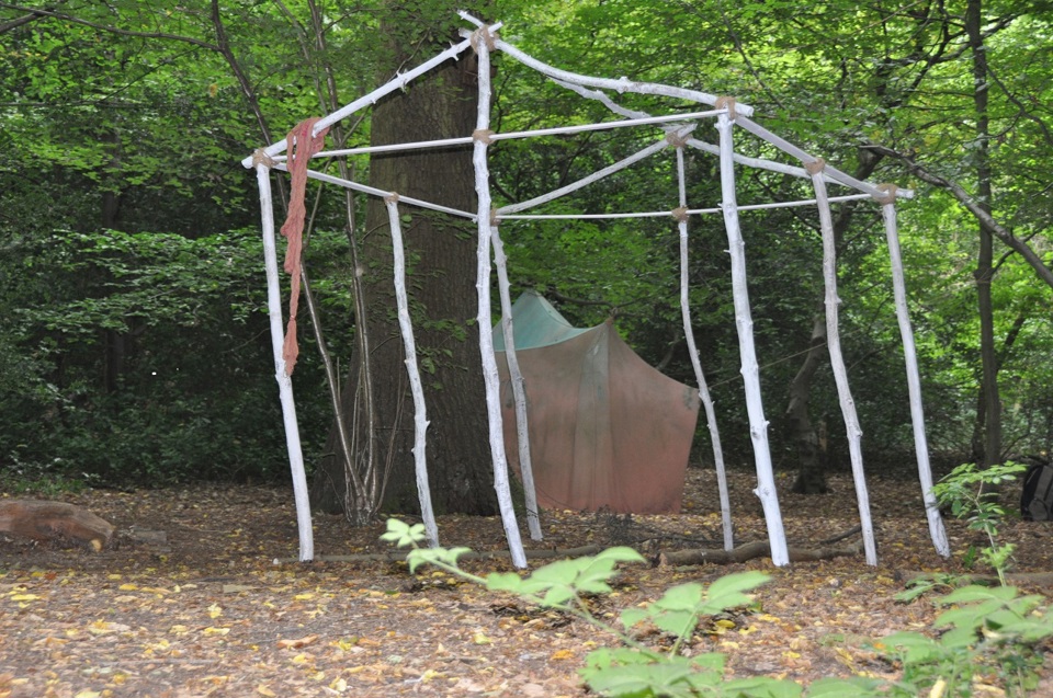 Velvet Zoe Ramos, Broken Home, 2010, found wood, twigs, mud and painted cotton scrim, installation view Highgate Woods, dimensions variable. The Power of Art #91 Velvet Zoe Ramos 'Broken Home'